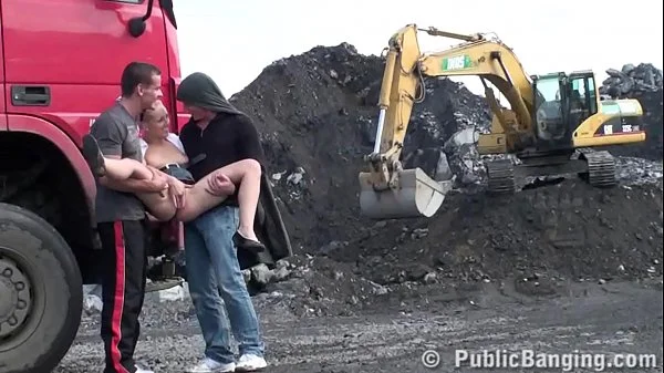 A very cute blonde young lady is fucked in public threesome at a construction site videos