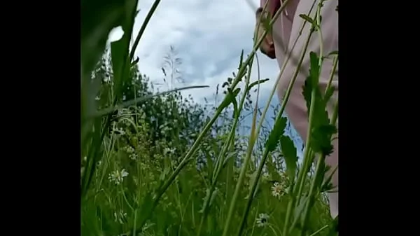 Naked horny MILF in a chamomile field masturbates, pisses and wards off a wasp / Angela-MILF videos