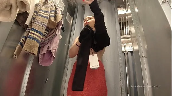 I try on clothes in fitting room with open curtain. videos