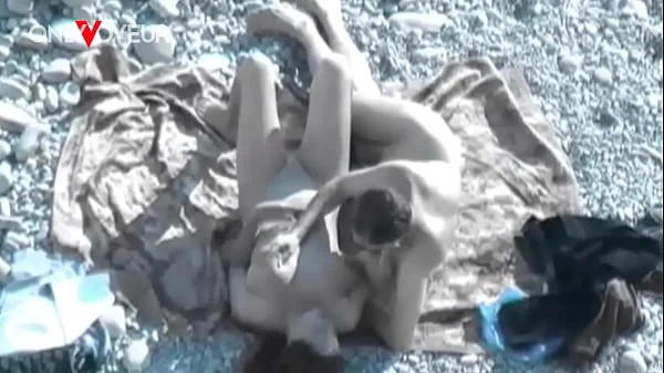 Beach Voyeur. Hot babe with big natural tits gives head on a public beach videos