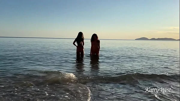 Two naked beauties swim in the sea at dawn videos