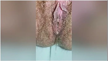 Detailed Close-up Footage Of A Hairy Pussy Girl Urinating From Her Pee Hole And Farting Loudly videos