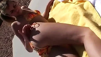 Hot blonde model shows off her body in a bikini in public videos