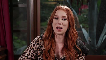 The red head Madison Morgan shows her assets in a captivating video videos