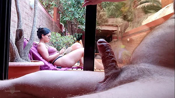 My stepson takes out his big cock on the terrace, gets excited looking at me behind the window and showing his erection to the neighbors. My nipples are very hard and I'm not wearing a bra. videos