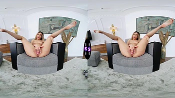 A blonde girl rubs her shaved pussy on the sofa in virtual reality videos