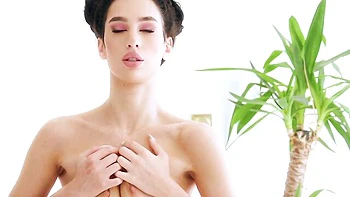 Bitchy brunette Kama Oxi stimulates her shaved pussy with love videos