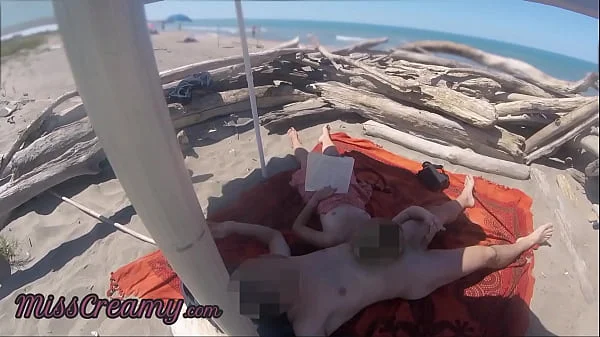 Risky Public Handjob on the Canary Beach Caught reading a book - MissCreamy videos